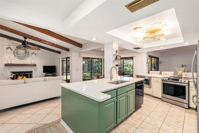 kitchen featuring sink, stainless steel electric range, a kitchen island with sink, a fireplace, and light tile patterned flooring