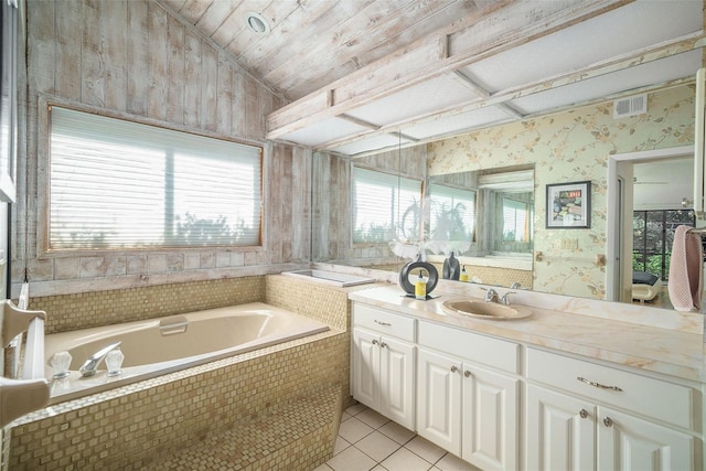 bathroom featuring tile patterned floors, vanity, and a relaxing tiled tub