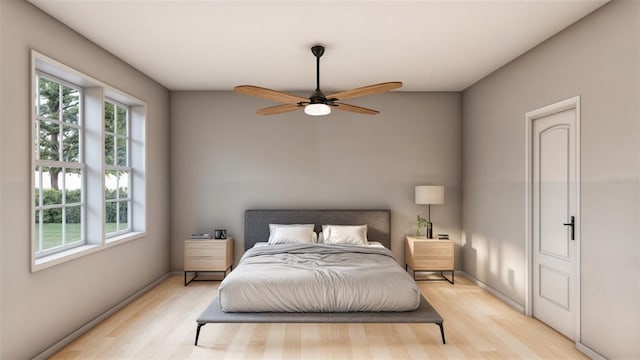 bedroom with ceiling fan and light hardwood / wood-style flooring