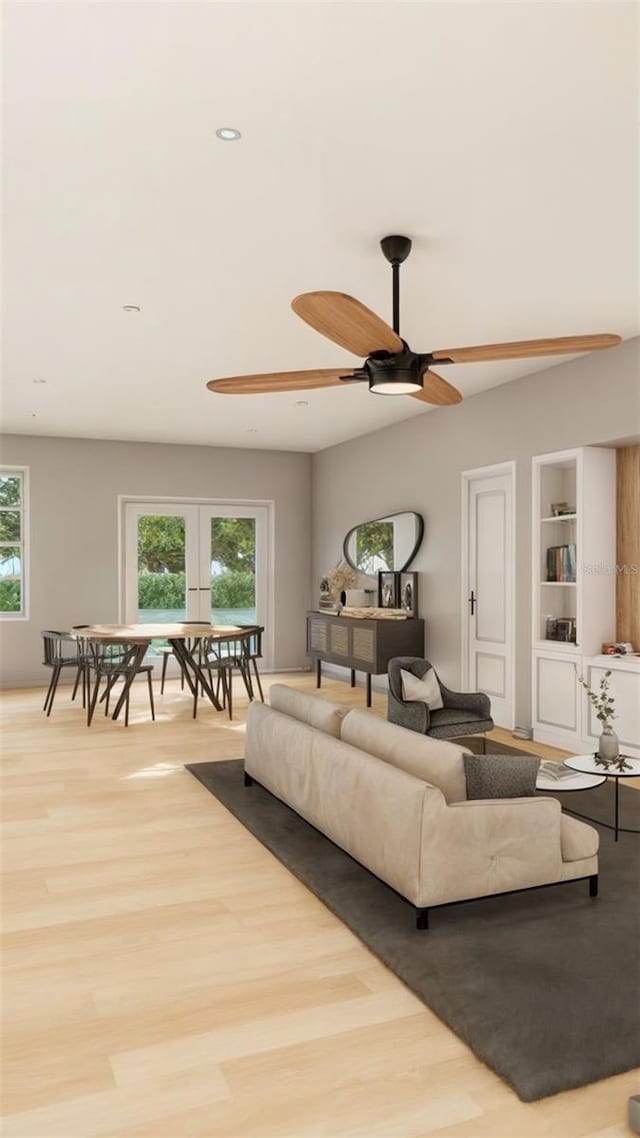 living room with ceiling fan, light wood-type flooring, a wealth of natural light, and french doors