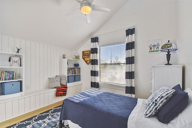 bedroom featuring ceiling fan, wood-type flooring, and lofted ceiling