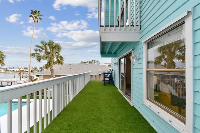 view of yard with a balcony and a water view