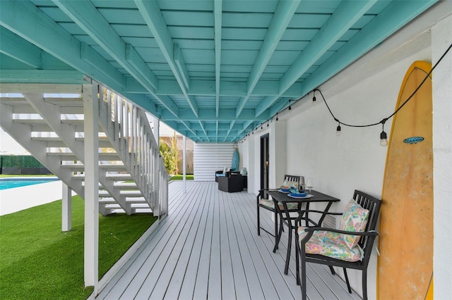 wooden terrace featuring a yard