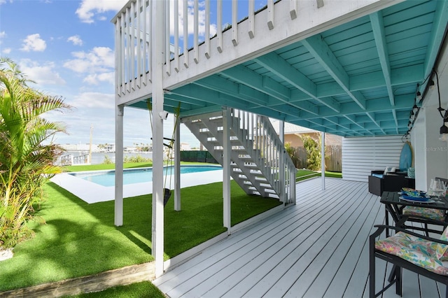 wooden deck featuring a yard