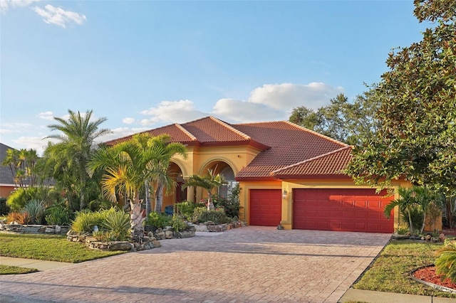 mediterranean / spanish-style house featuring a garage