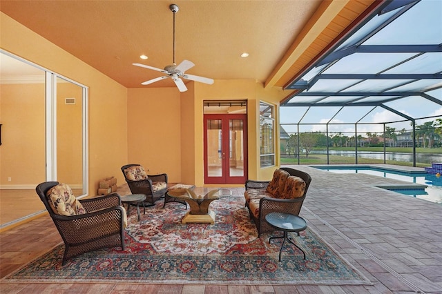 view of patio with outdoor lounge area, ceiling fan, glass enclosure, and french doors