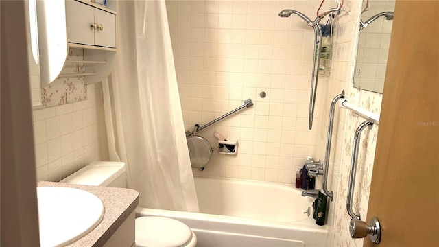 full bathroom featuring shower / tub combo, vanity, toilet, and tile walls