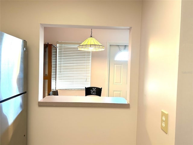 room details featuring decorative light fixtures and stainless steel refrigerator