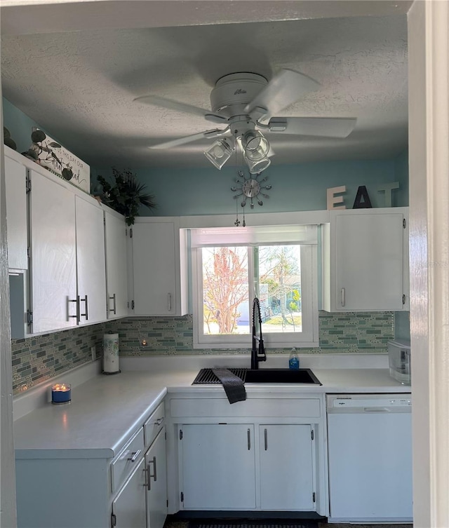 kitchen featuring white cabinets, ceiling fan, dishwasher, and sink