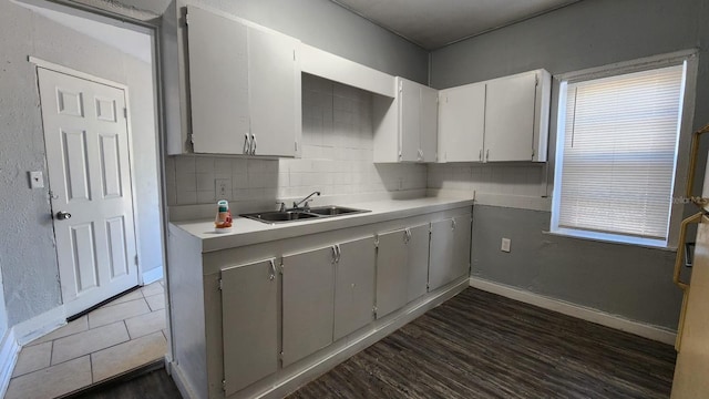 kitchen featuring decorative backsplash, dark hardwood / wood-style flooring, plenty of natural light, and sink