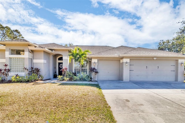 view of front facade featuring a front yard and a garage