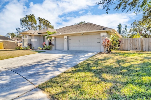 ranch-style house featuring a garage and a front lawn