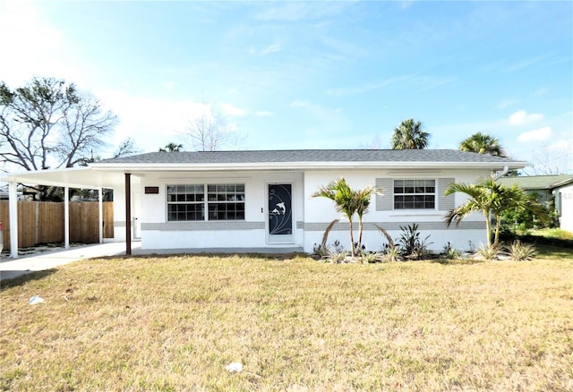 view of front of property featuring a front lawn and a carport