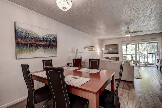 dining room featuring ceiling fan with notable chandelier, wood-type flooring, and a textured ceiling