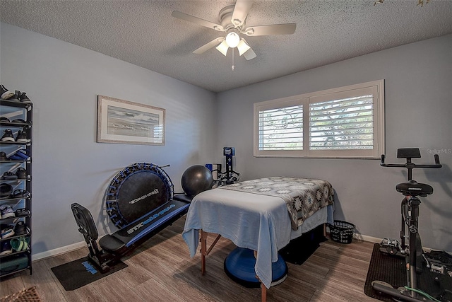 bedroom featuring hardwood / wood-style floors, ceiling fan, and a textured ceiling