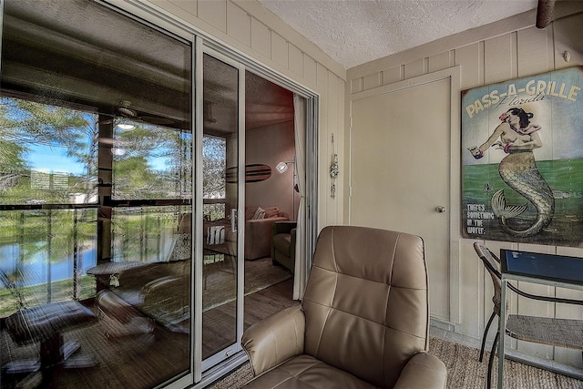 sunroom / solarium featuring a water view