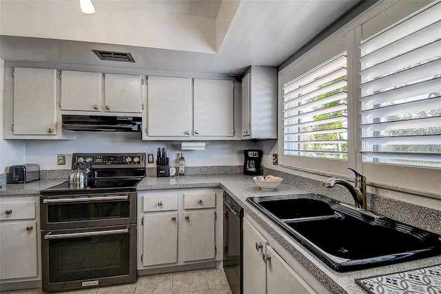 kitchen featuring white cabinets, sink, light tile patterned floors, double oven range, and dishwasher