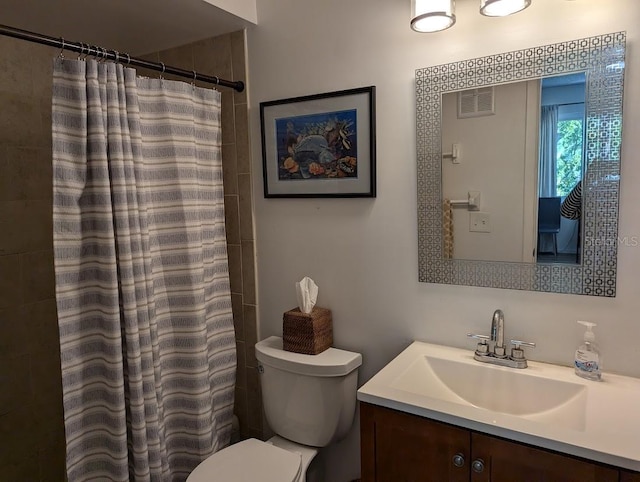 bathroom with a shower with shower curtain, vanity, and toilet