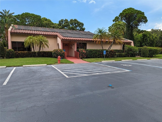 view of parking / parking lot featuring a yard