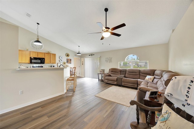 living room with dark hardwood / wood-style floors, high vaulted ceiling, and ceiling fan