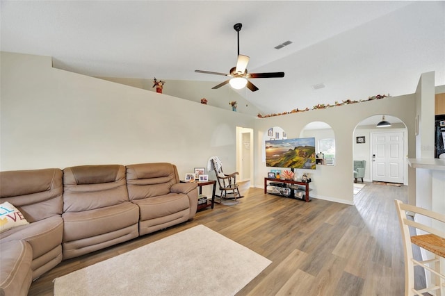 living room with ceiling fan, vaulted ceiling, and hardwood / wood-style flooring