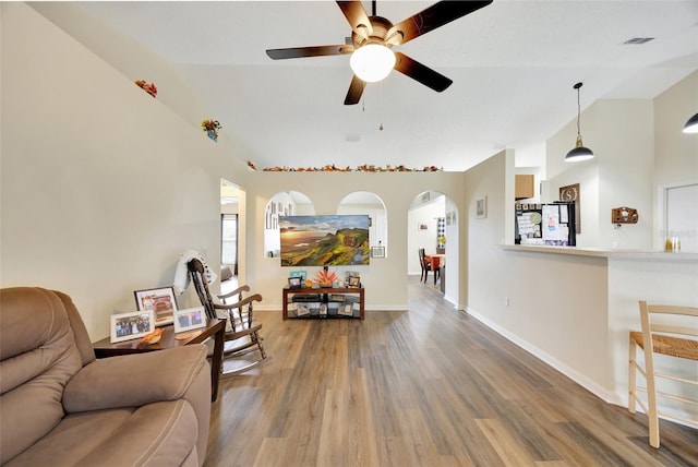 living room featuring hardwood / wood-style floors, ceiling fan, and lofted ceiling