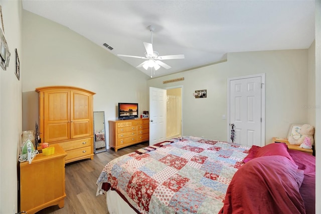 bedroom featuring wood-type flooring, vaulted ceiling, and ceiling fan