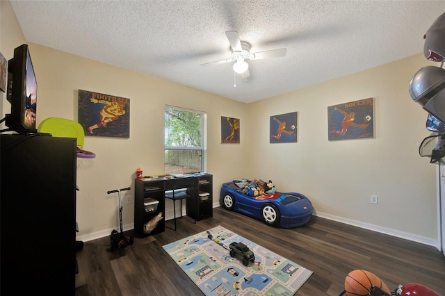 office area with a textured ceiling, ceiling fan, and dark hardwood / wood-style floors