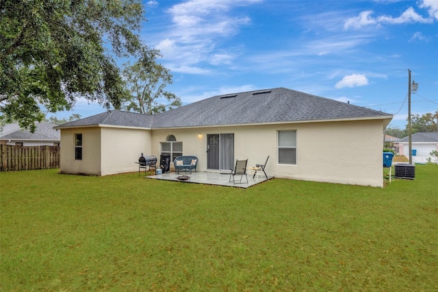 back of property featuring a lawn, a patio area, and central AC