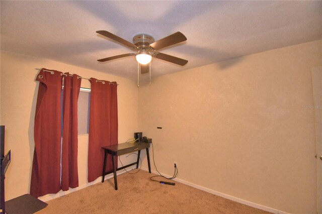 misc room with light colored carpet and ceiling fan