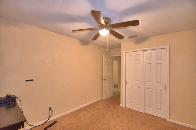 unfurnished office with light carpet and ceiling fan