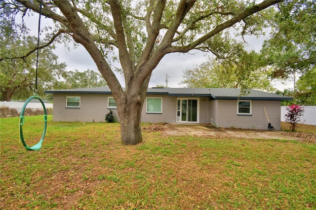 rear view of property with a lawn