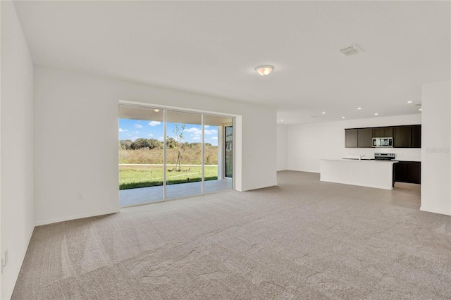 unfurnished living room with light carpet