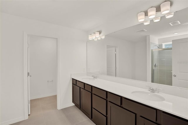 bathroom with tile patterned flooring, vanity, and a shower with shower door