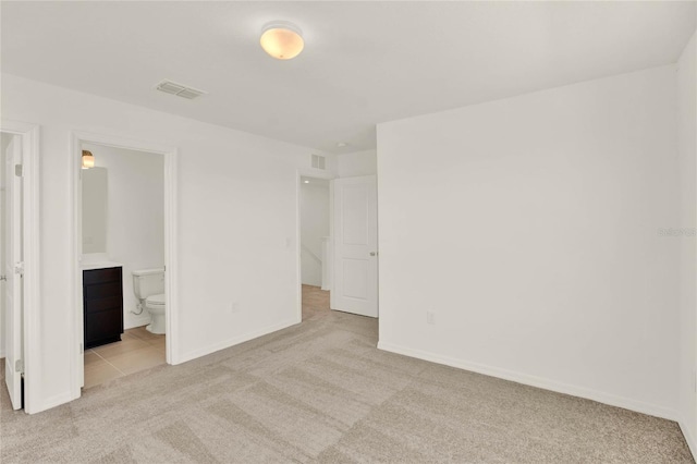 unfurnished room featuring light colored carpet