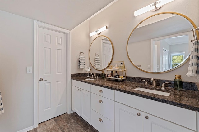 bathroom featuring vanity, hardwood / wood-style floors, and ornamental molding