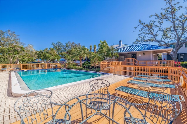 community pool featuring a patio and fence