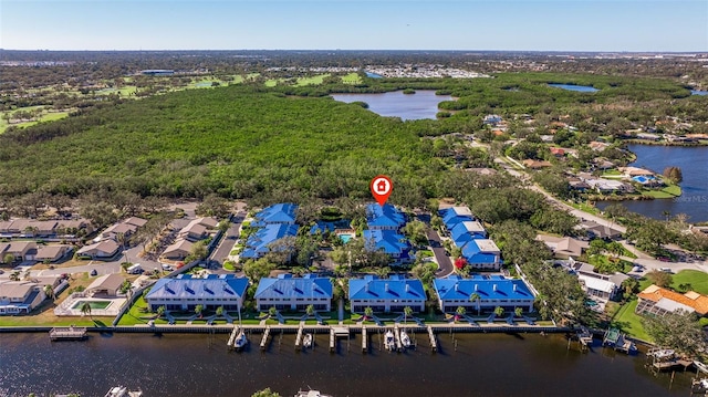 drone / aerial view featuring a residential view and a water view