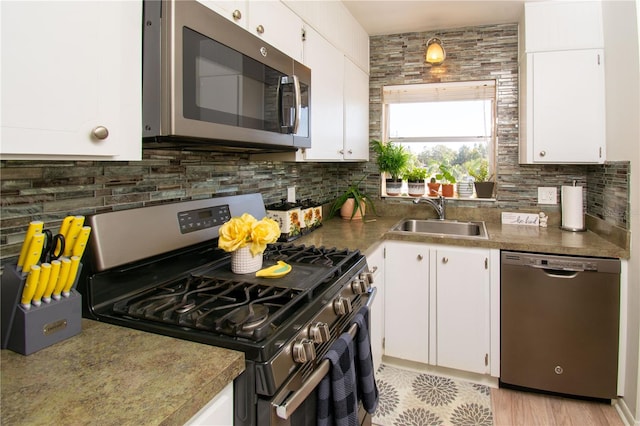 kitchen with appliances with stainless steel finishes and white cabinetry