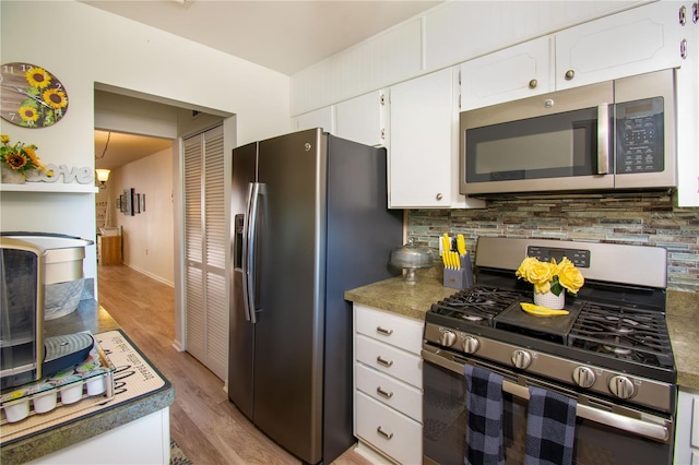 kitchen featuring backsplash, stainless steel appliances, light hardwood / wood-style flooring, and white cabinetry