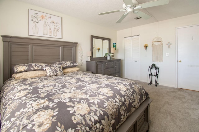 bedroom featuring ceiling fan, a closet, carpet, and a textured ceiling