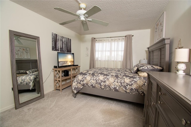 carpeted bedroom featuring a textured ceiling and ceiling fan