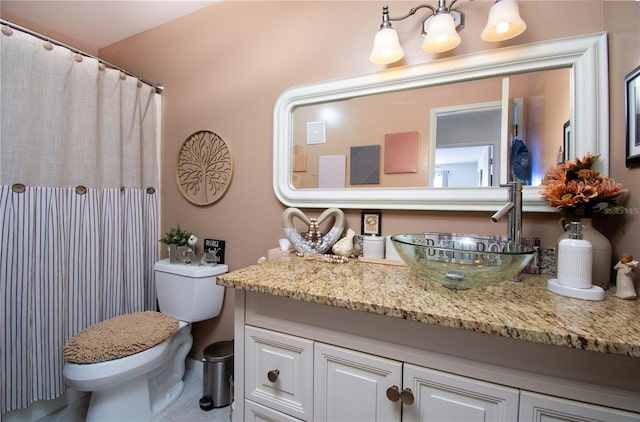 bathroom featuring tile patterned floors, vanity, and toilet