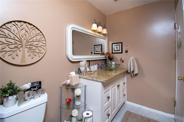 bathroom with tile patterned floors, vanity, and toilet