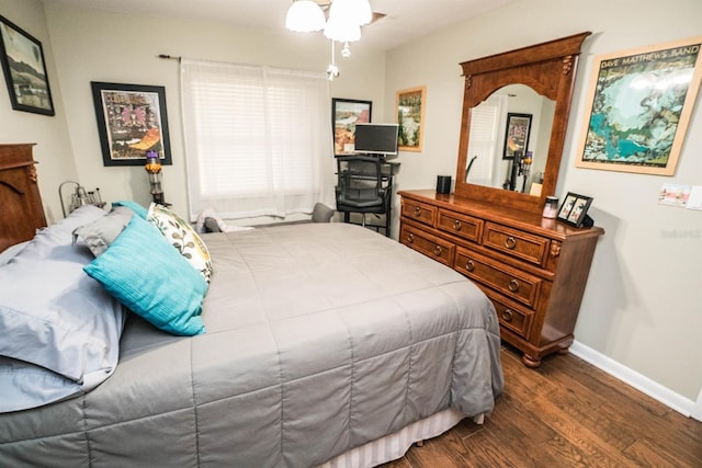 bedroom with dark hardwood / wood-style flooring