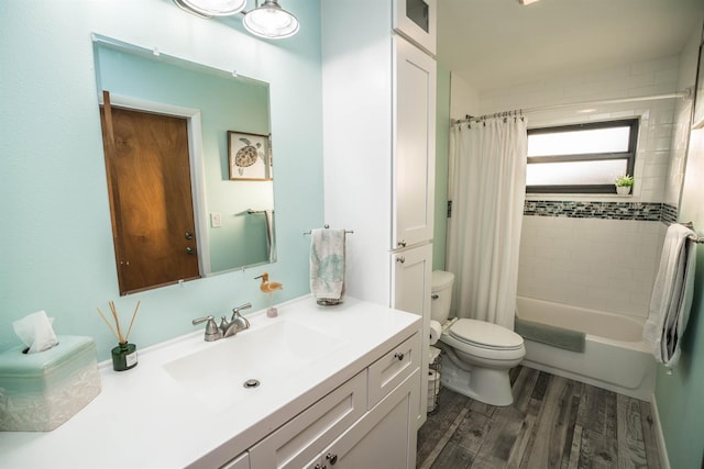 full bathroom with shower / bath combo with shower curtain, hardwood / wood-style floors, vanity, and toilet