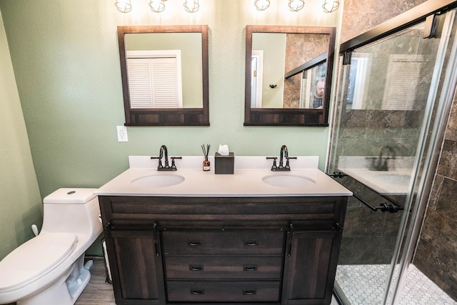 bathroom with vanity, toilet, and a shower with shower door