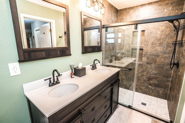 bathroom featuring vanity and an enclosed shower