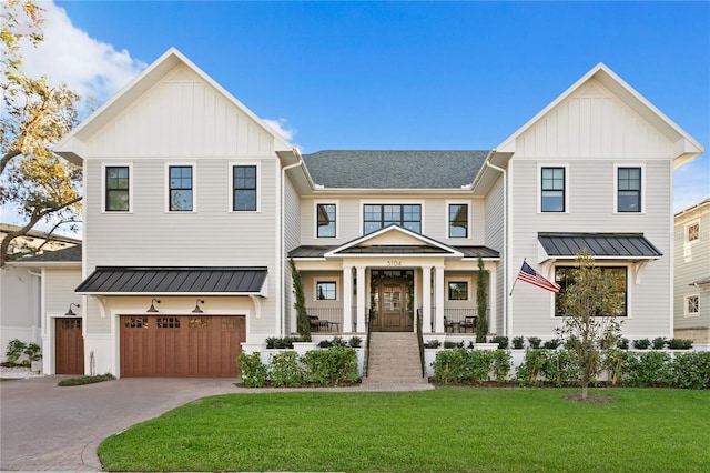 modern inspired farmhouse featuring a front yard, covered porch, and a garage