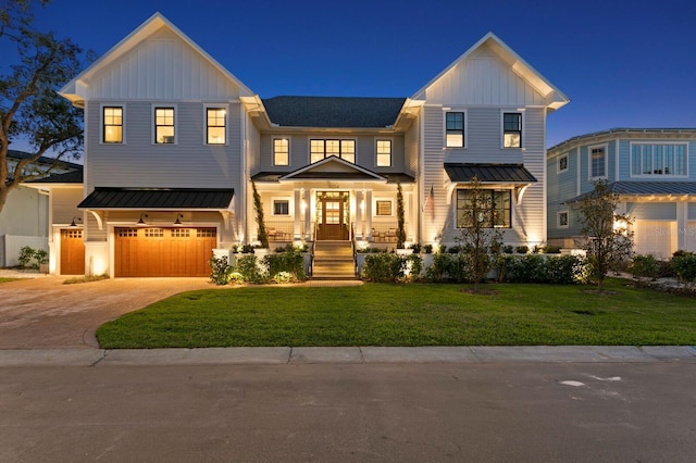 modern farmhouse style home with a front yard, covered porch, and a garage